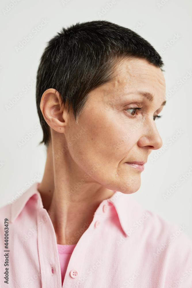 Fototapeta premium Minimal side view portrait of confident mature woman with short haircut looking away, real beauty, recovery concept