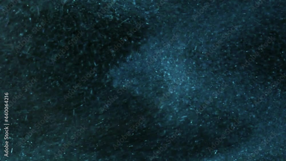 Slow motion shot of Blue dust particles flowing in black Background
Slow motion shot of Blue dust particles flowing in black Background