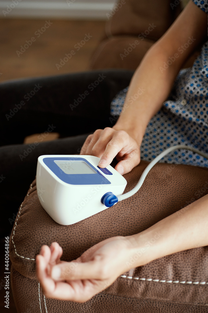 Fototapeta premium measures blood pressure with a sphygmomanometer