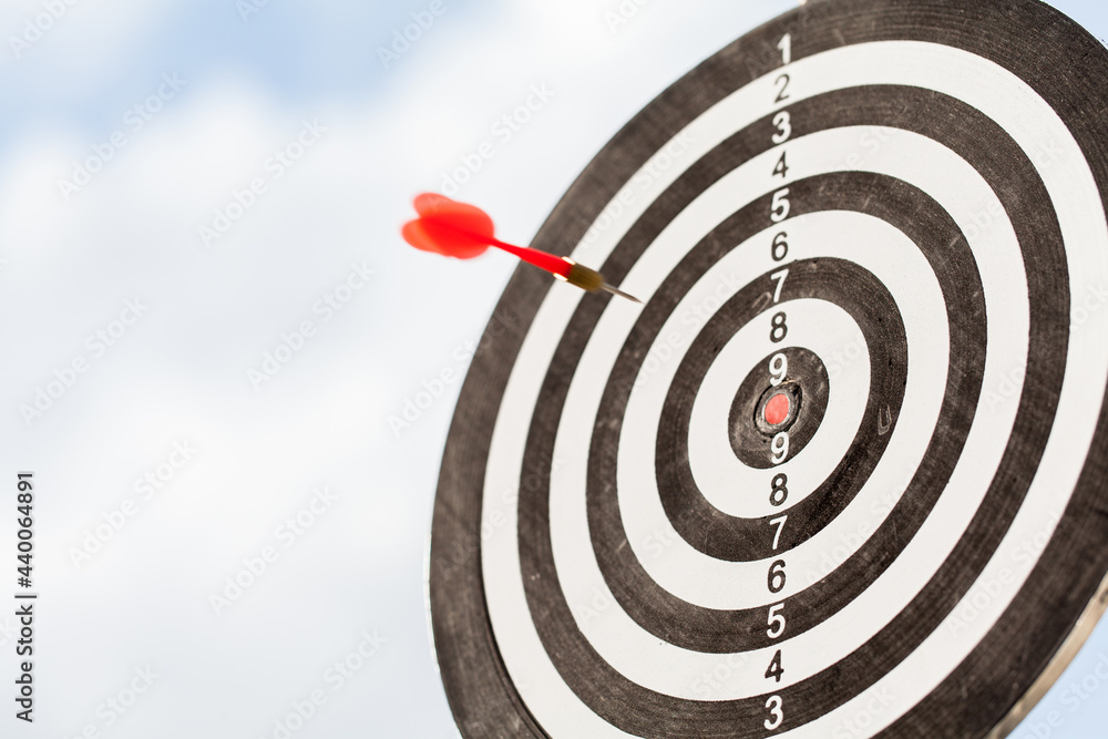 red dart fly to hit the center of dartboard. red dart fly to hit the center of dartboard.