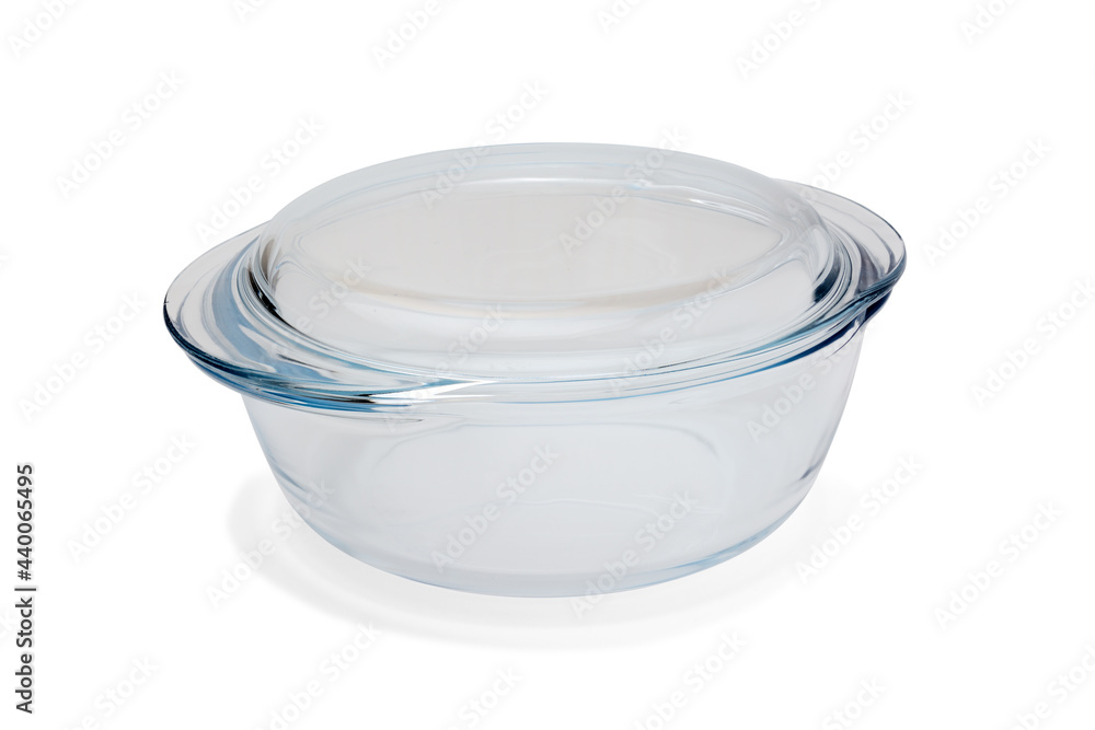 Transparent pan for cooking and baking made of heat-resistant glass, closed with a lid. Close-up on a white background with a shadow Transparent pan for cooking and baking made of heat-resistant glass, closed with a lid. Close-up on a white background with a shadow