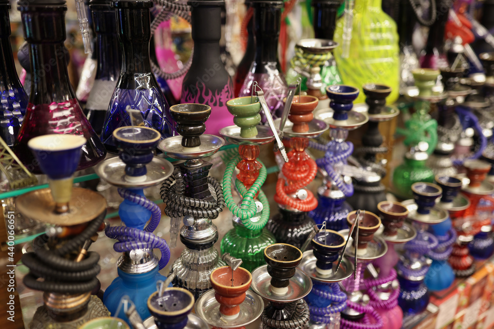 Many multicolored hookahs standing on counter of store