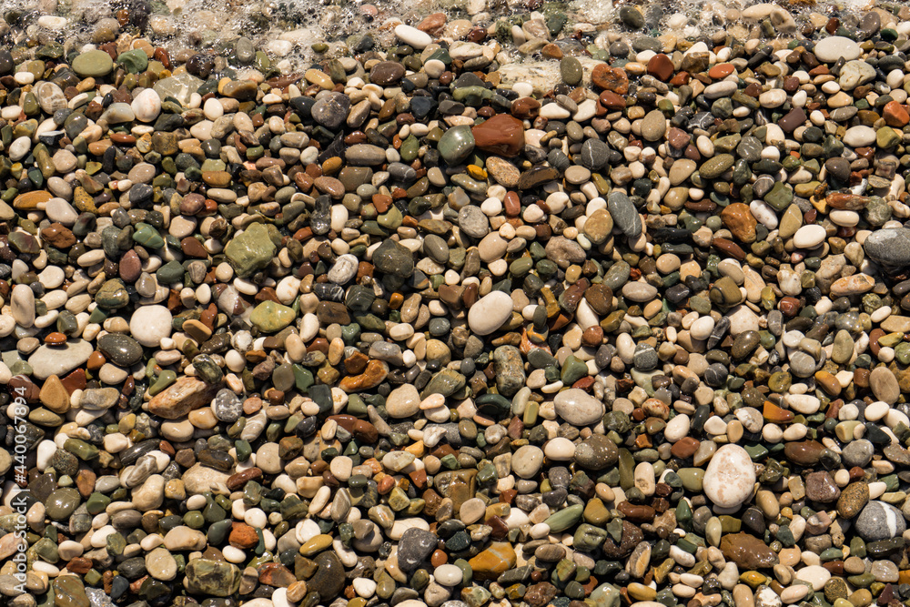 Sea stones background made of a closeup of a pile of pebbles.Relaxing pebbles background for nature pattern concept Sea stones background made of a closeup of a pile of pebbles.Relaxing pebbles background for nature pattern concept