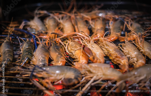 Grilled river prawns over charcoal fire at a family party