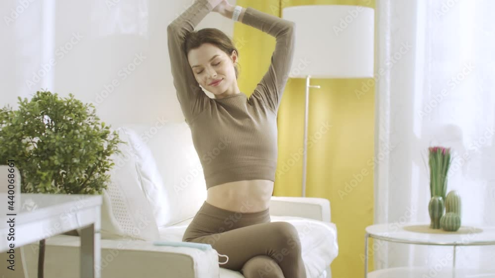 An attractive woman is stretching and raising up her hands An attractive woman is stretching and raising up her hands