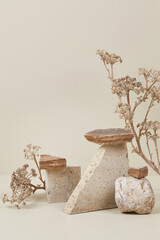 Abstract nature scene with composition of stones and dry flowers. Neutral beige background for cosmetic, beauty product branding, identity and packaging. Natural pastel colors. Copy space, front view.