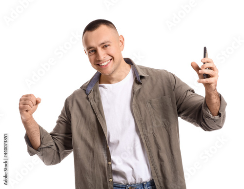 Happy young man with mobile...