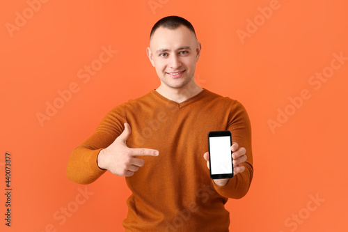 Young man with mobile phone...