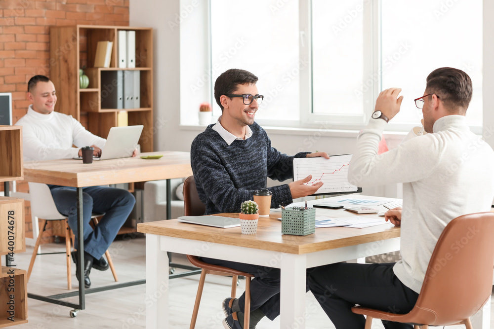 Male accountant working with client in office Male accountant working with client in office