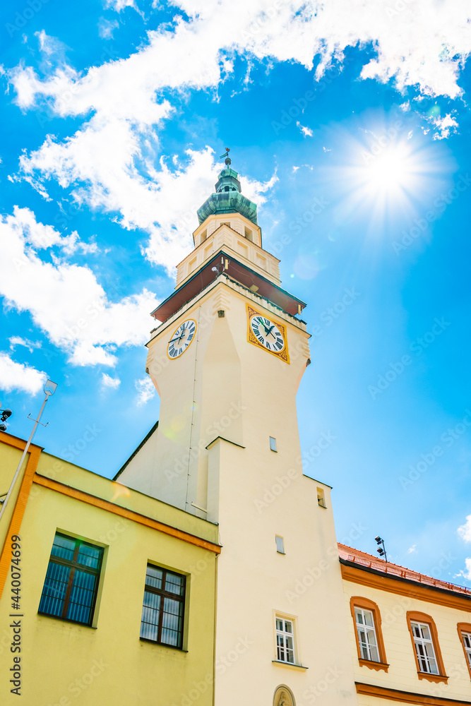 City town hall and clock tower at Boskovice city, South Moravia region, Czech republic. Summer day, blue sky.
