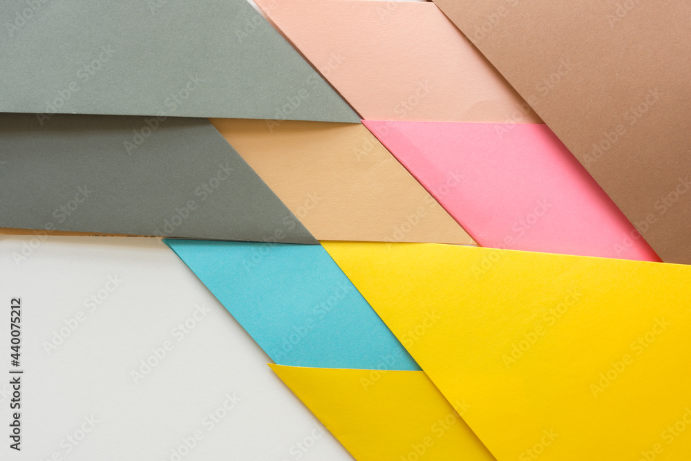 triangle-shaped folded construction paper background in grey sand blue yellow and pink on white triangle-shaped folded construction paper background in grey sand blue yellow and pink on white