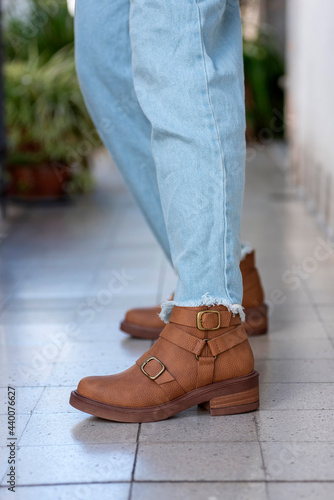 woman legs wearing brown black leather fashion shoes with casual clothes with very stylish bottom