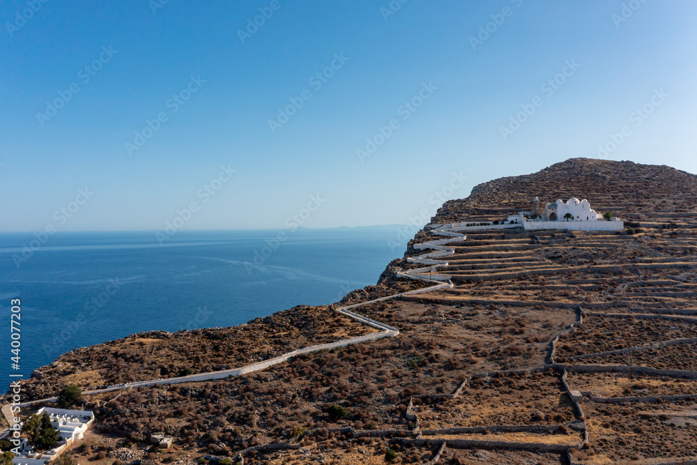 Folegandros island, Greece, Cyclades. Panagia Virgin Mary Church and long zigzag road.
