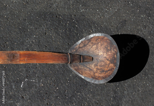 Coconut shell spoon from Indonesia on black background. often used so that it seems classic.