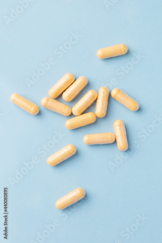 Coenzyme Q10 capsules. Dietary supplements. Bright paper background. Top view. Copy space. 