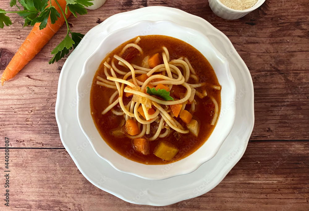 Italian minestrone vegetable soup with bacon, carrots, celery, leek, tomatoes, spaghetti noodles and parmesan. Italian minestrone vegetable soup with bacon, carrots, celery, leek, tomatoes, spaghetti noodles and parmesan.