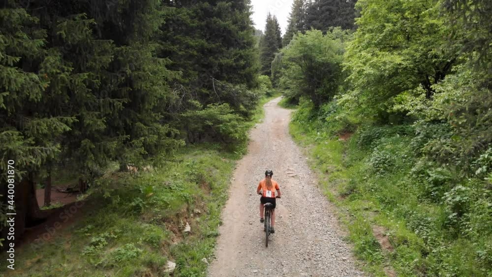 Man ride bicycle on the mountain road aerial shot Man ride bicycle on the mountain road aerial shot