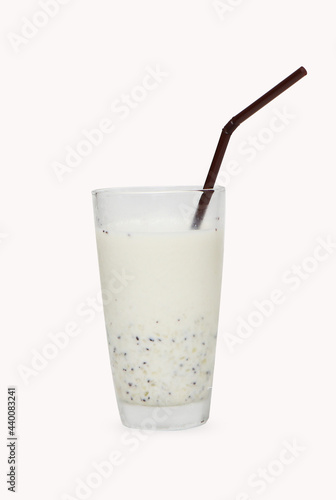 fresh kiwi green smoothie milkshake prepared with milk. Presented in a high glass with straw isolated on white background