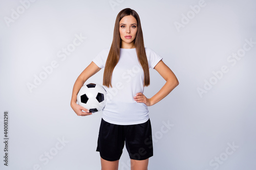 I'm ready Photo of serious lady skilled player soccer women team stand calm listen coach hold leather ball wear football uniform t-shirt shorts isolated white color background