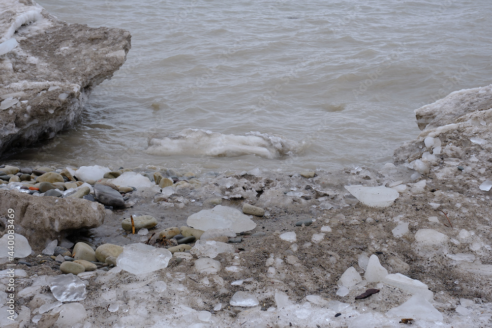 Ice floe buildup along the rocky shoreline of Lake Michigan on the United States side on a cloudy cold winter day Ice floe buildup along the rocky shoreline of Lake Michigan on the United States side on a cloudy cold winter day