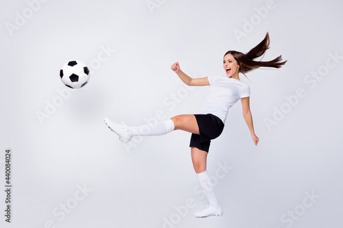 Full body photo of excited captain lady player soccer women team kick leg ball yelling teammate wear football uniform t-shirt shorts boots knee socks isolated white color background