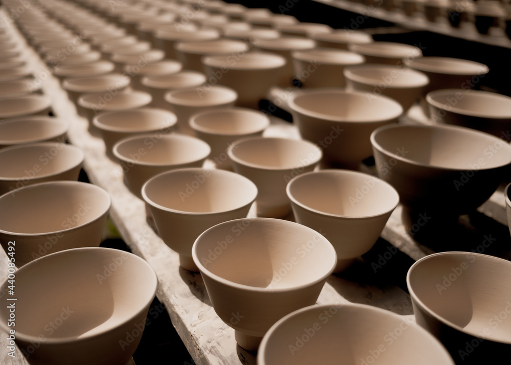 High angle shot of production line of ceramic cups - obrazy, fototapety, plakaty 