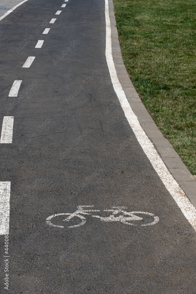 Fototapeta premium bike path, bicycle lane, side of the grass field,