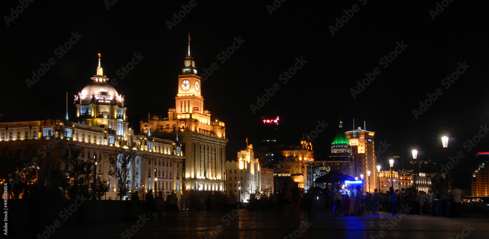 The Bund in Shanghai, China: View of illuminated colonial buildings at night along the Bund in Shanghai. The Bund is popular for tourists and local Shanghai people to walk at night.
