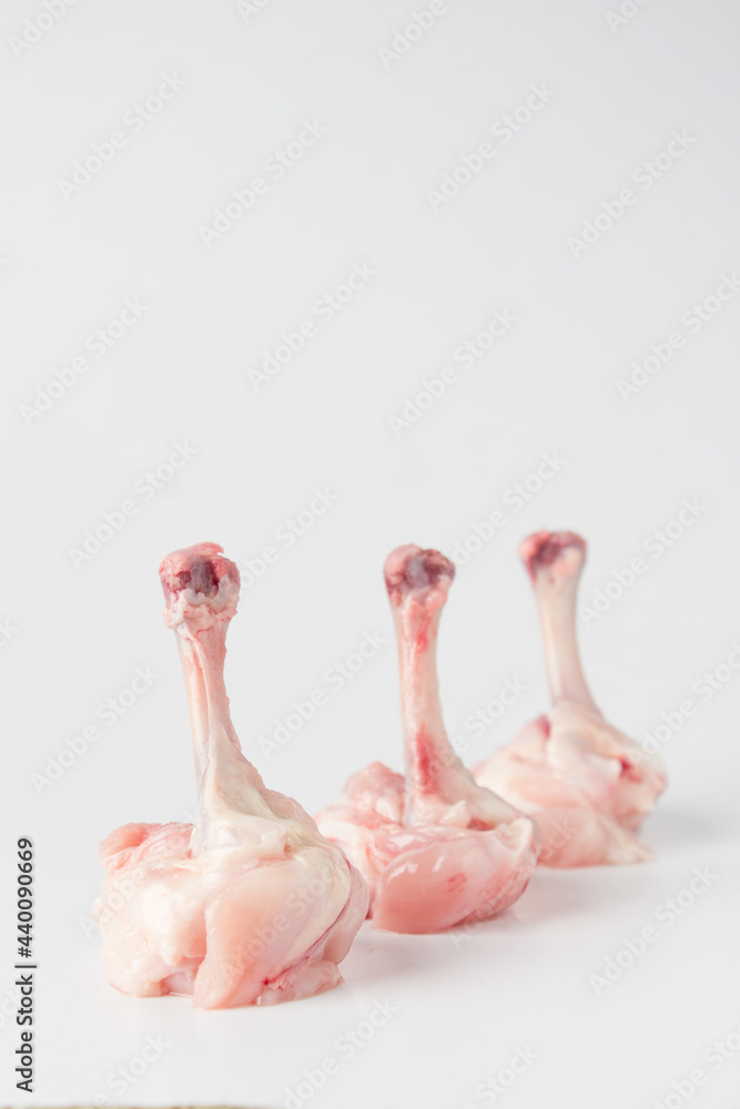 Naklejka premium Raw chicken Lollypops, white background, isolated.