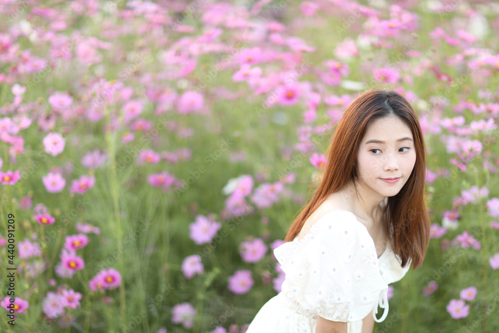 Beautiful young woman with white dress on garden background