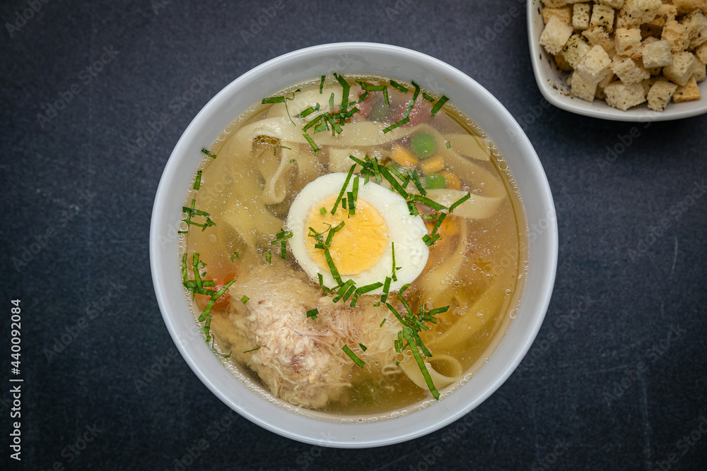 Broth with croutons on a dark table
Broth with croutons on a dark table