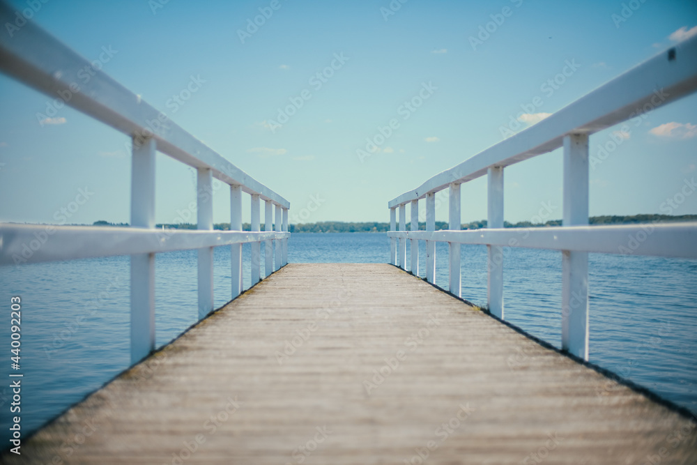 wooden pier in front of blue water