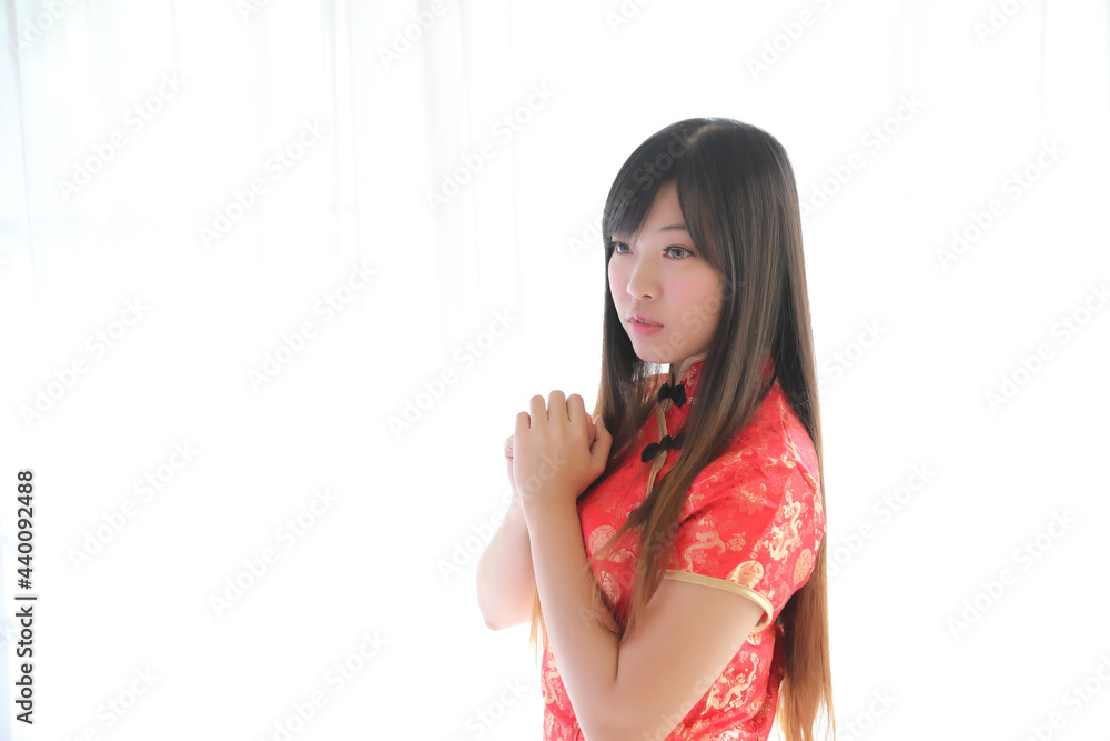 beauty woman wear red cheongsam looking and smile in chinese new year beauty woman wear red cheongsam looking and smile in chinese new year