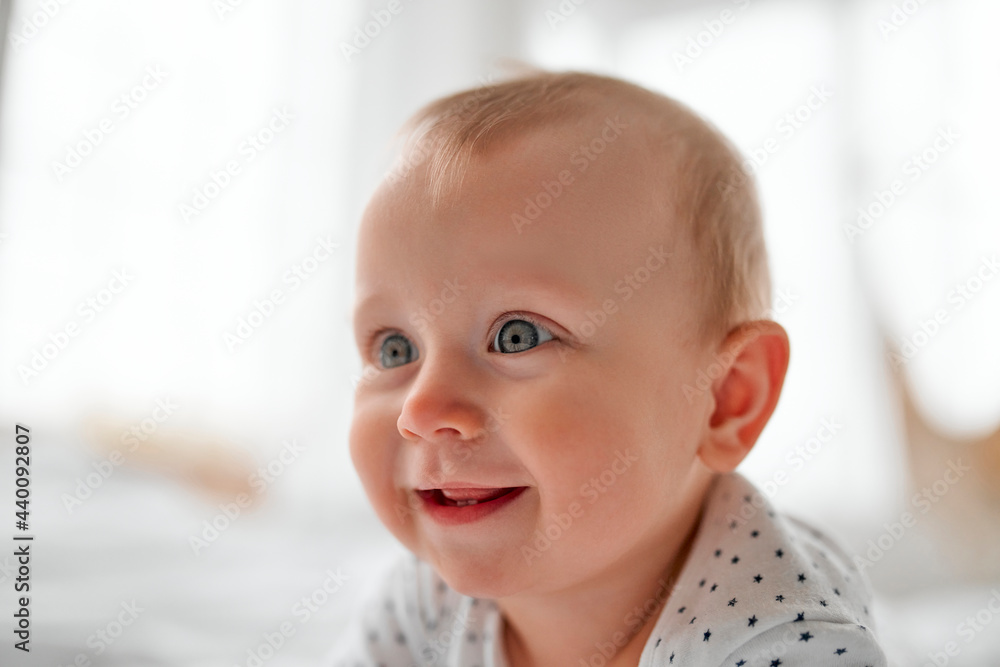 Adorable baby boy in white sunny bedroom. Newborn child relaxing in bed. Nursery for young children. Textile and bedding for kids. Family morning at home. New born kid during tummy time. Adorable baby boy in white sunny bedroom. Newborn child relaxing in bed. Nursery for young children. Textile and bedding for kids. Family morning at home. New born kid during tummy time.