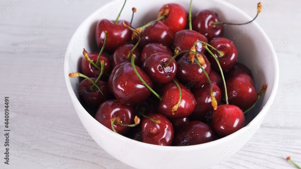 Fresh cherry on plate on wooden white background. fresh ripe cherries. sweet cherries. Fresh cherry on plate on wooden white background. fresh ripe cherries. sweet cherries.