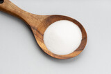 Collagen powder on wooden spoon isolated on gray background