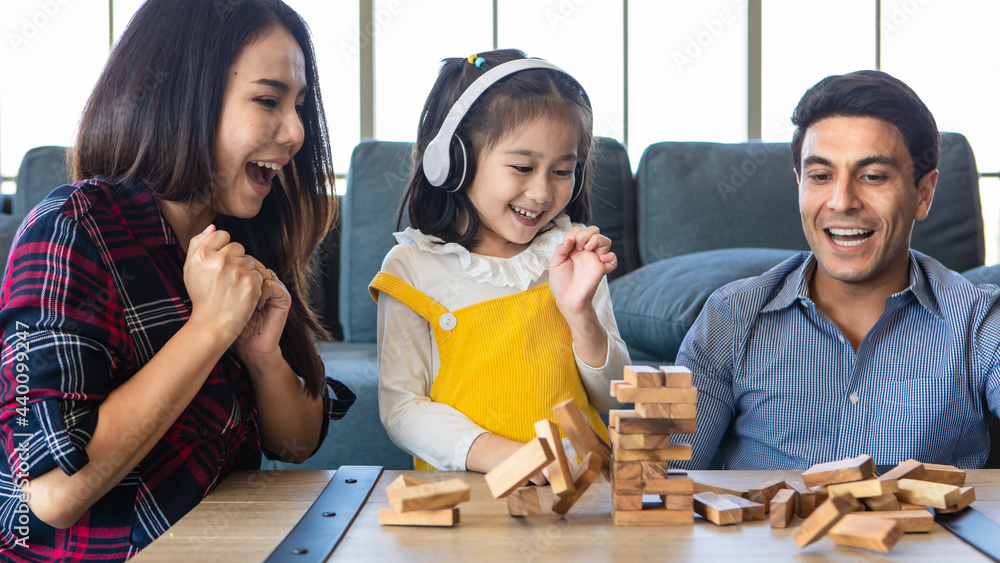 Mixed race family, daughter and caucasian dad and Asian mom, playing wood game together with fund and excited. Mixed race family, daughter and caucasian dad and Asian mom, playing wood game together with fund and excited.