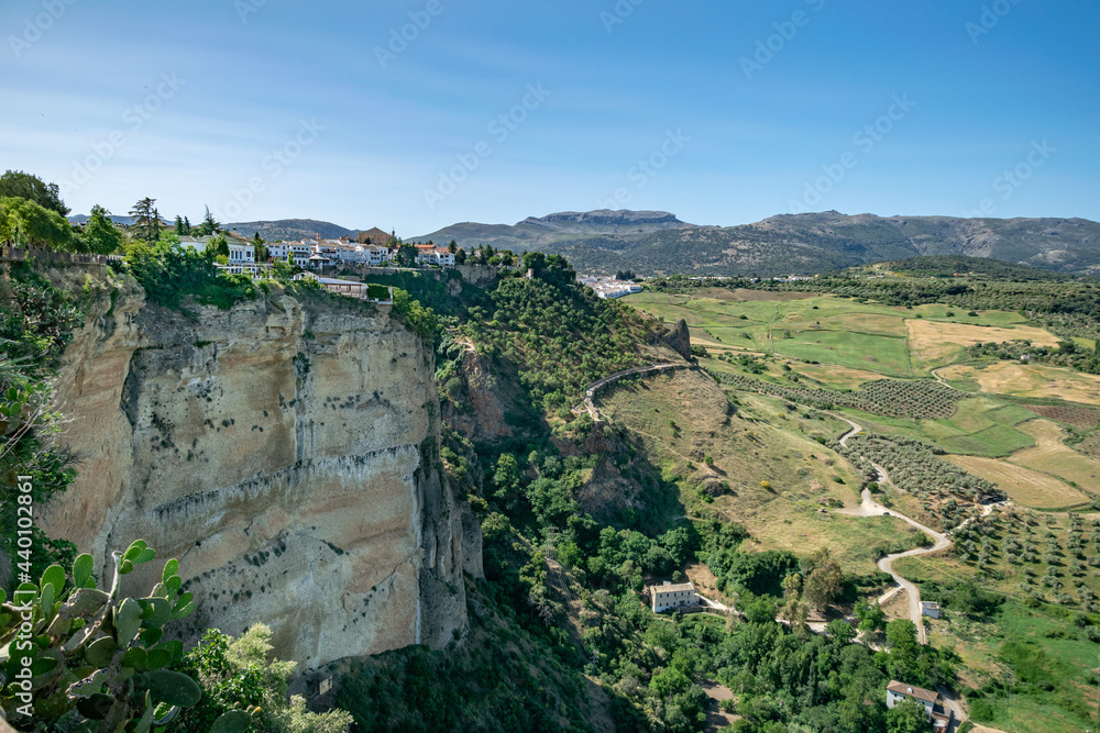 a landscape view of the green valleys and cliffsides surrounding Ronda in Southern Spain 