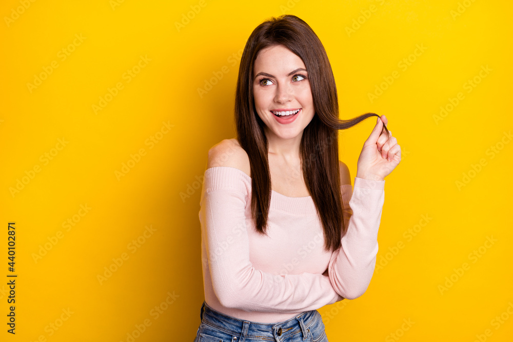 Photo of optimistic brunette lady hand hair look empty space wear pink shirt isolated on yellow color background Photo of optimistic brunette lady hand hair look empty space wear pink shirt isolated on yellow color background