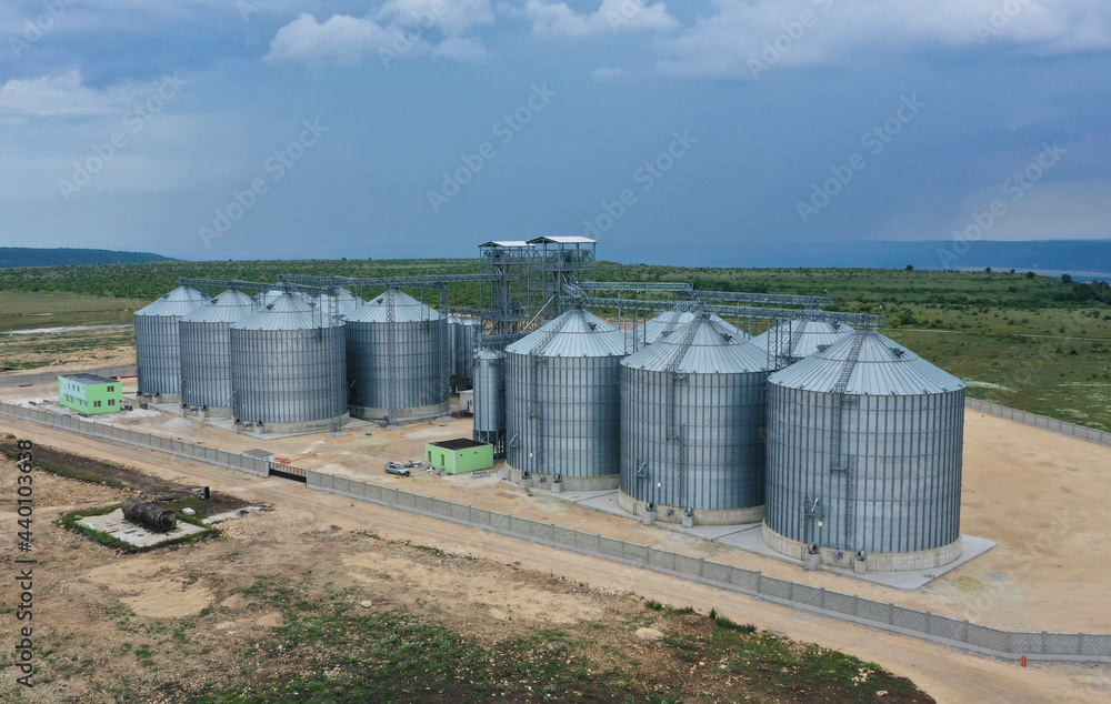 New industrial grain silos grain storage tanks from drone, aerial view New industrial grain silos grain storage tanks from drone, aerial view