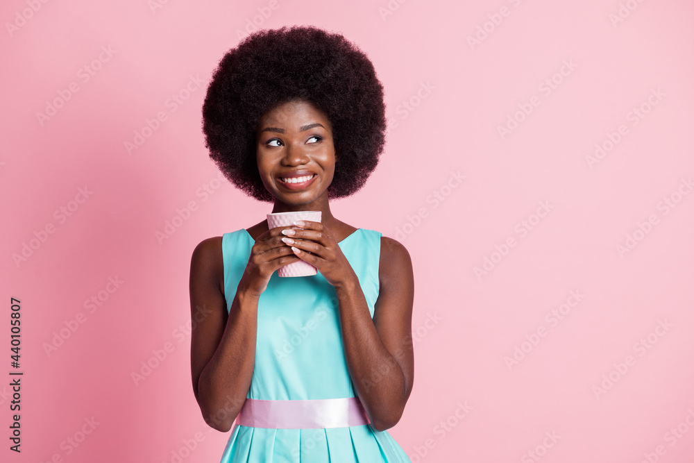 Photo of young happy cheerful smiling afro girl look copyspace dreaming drink coffee isolated on pink color background