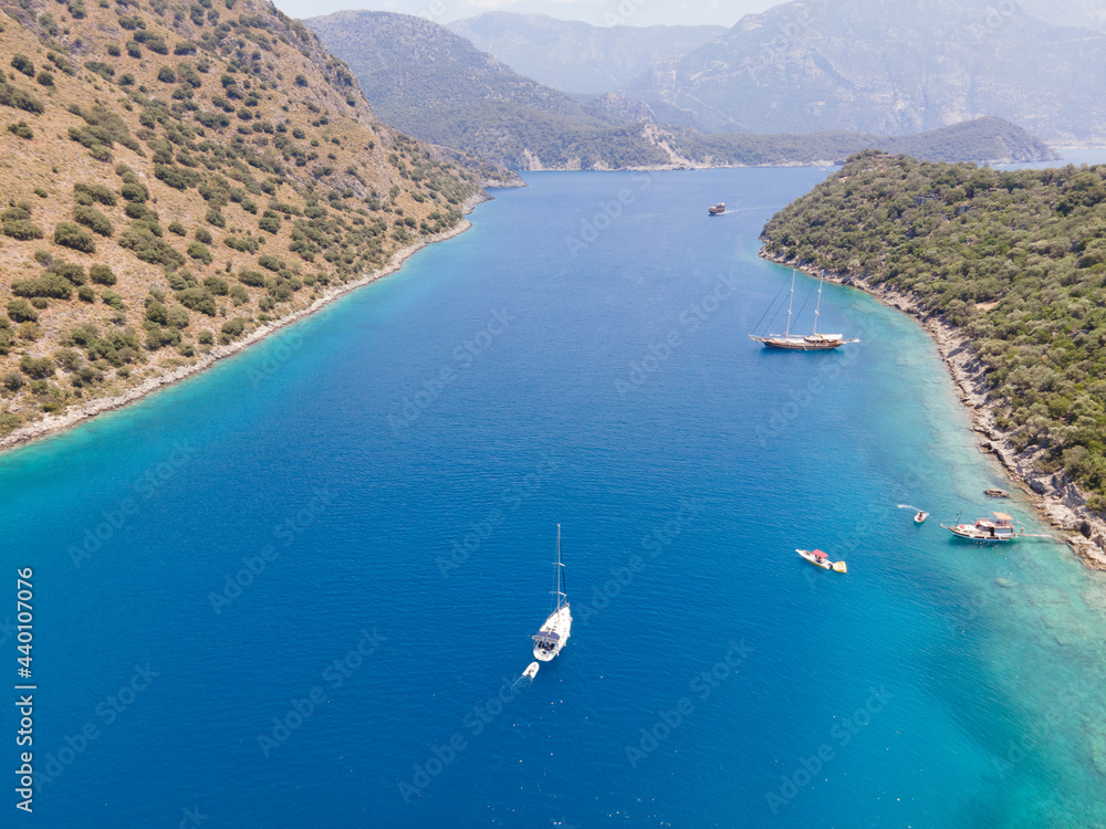 Passage between mainland and St.Nicholas island near Oludeniz (Turkey) with sailing boats and yachts anchored
