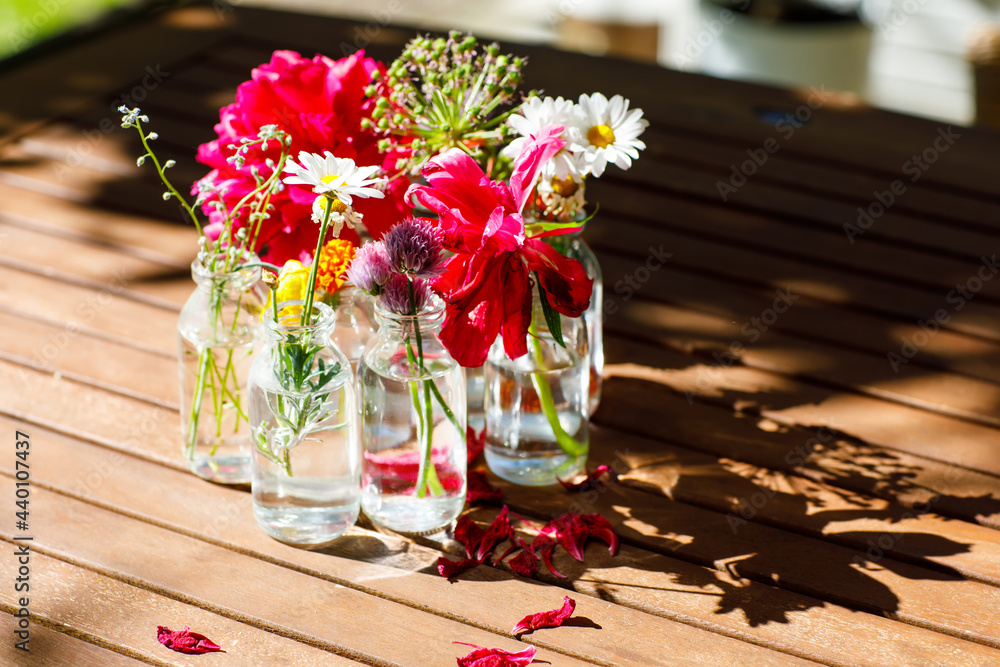 Variation or group of garden flowers in small vases or bottles. Colorful  flower arrangement or decoration in rainbow colors. Home or garden, terrace  decor concept. Stock Photo | Adobe Stock