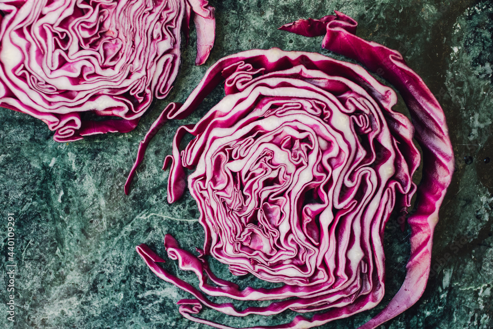 Obraz premium sliced red cabbage steak on green background