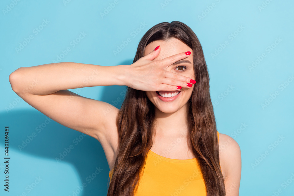 Photo portrait girl smiling looking through fingers playful childish isolated pastel blue color background Photo portrait girl smiling looking through fingers playful childish isolated pastel blue color background