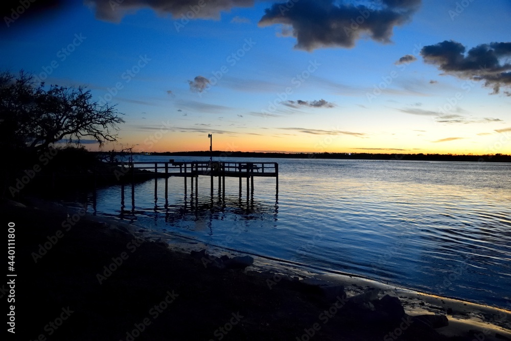 Fishing pier at sunset on the river at Florida, USA.