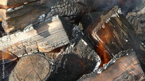Burning firewood close-up. Burning with orange and yellow flames.