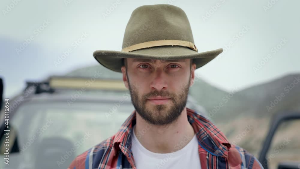 Portrait Of Young Guy In Hat. Cute Young Man With Beard In Nature. Behind Him Car. Portrait Of Young Guy In Hat. Cute Young Man With Beard In Nature. Behind Him Car.