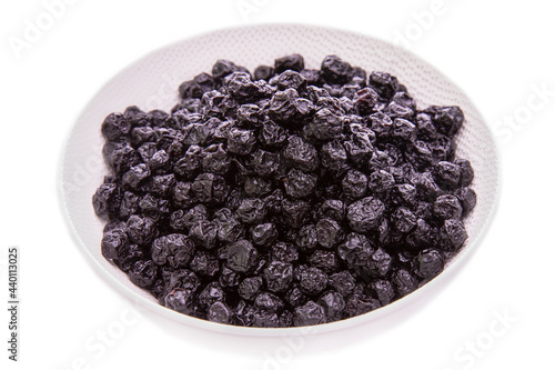 blueberries dry berry in a white dish on a white background.Isolated products and items