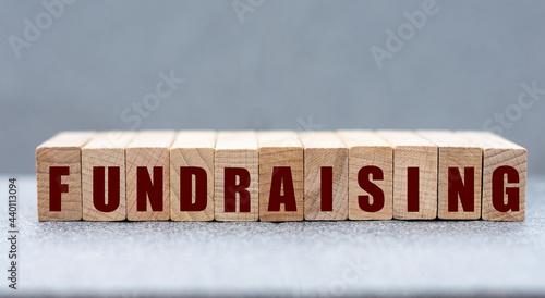 FUNDRAISING - word on wooden bars on a gray background